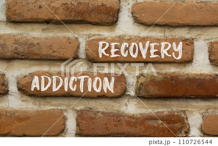 Addiction recovery symbol. Concept words Addiction recovery on beautiful brown brick wall. Beautiful brown brick wall background. Psychology addiction recovery concept. Copy space. 110726544