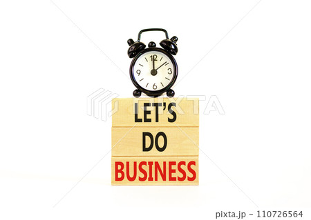let is do business symbol. Concept words let is do business on beautiful wooden blocks. Beautiful white table white background. Black alarm clock. let is do business concept. Copy space. 110726564