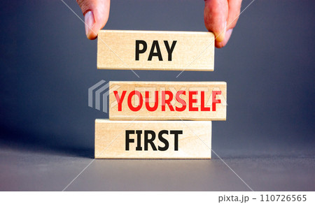 Pay yourself first symbol. Concept words Pay yourself first on beautiful wooden blocks. Beautiful grey table grey background. Businessman hand. Business and pay yourself first concept. Copy space. Pay yourself first symbol. Concept words Pay yourself first on beautiful wooden blocks. Beautiful grey table grey background. Businessman hand. Business and pay yourself first concept. Copy space. 110726565