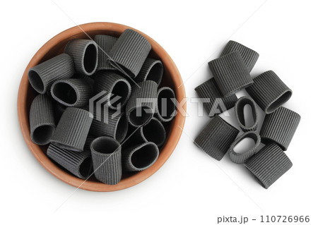 Black pasta with cuttlefish ink in ceramic bowl isolated on white background. Top view. Flat lay 110726966