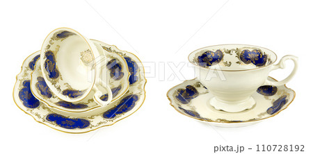 Vintage porcelain tea cups, saucer and dessert plate isolated on white background. Free space for text. Wide photo. Collage. Vintage porcelain tea cups, saucer and dessert plate isolated on white background. Free space for text. Wide photo. Collage. 110728192