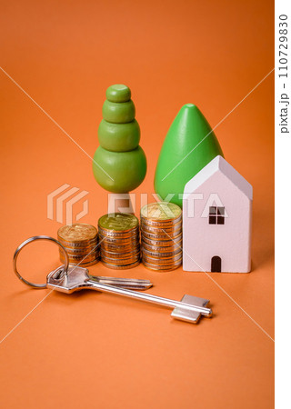 A small wooden house and keys as an idea for investing in your own home 110729830
