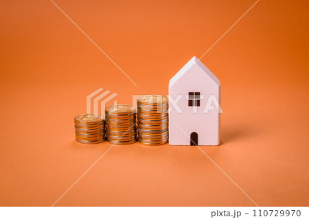 A small wooden house and keys as an idea for investing in your own home A small wooden house and keys as an idea for investing in your own home 110729970