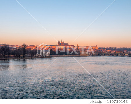Prague bridge over a river with a city in the background Prague bridge over a river with a city in the background 110730148