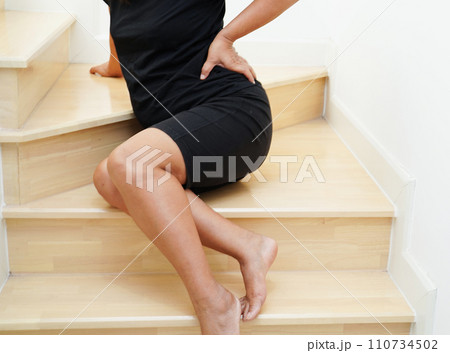 Asian lady woman injury from falling down on slippery surfaces stairs at home. 110734502