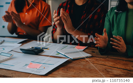 Cheerful business colleagues applauding in meeting at coworking office 110735140