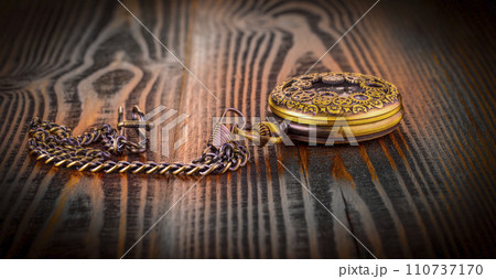 Antique pocket watch lying on old wooden background 110737170