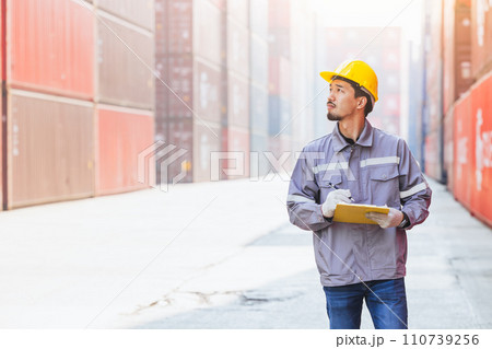 Japanese male smart worker working in container port cargo. Japan shipping logistics industry customs staff. 110739256