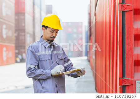 Japanese male smart worker working in container port cargo. Japan shipping logistics industry customs staff. 110739257