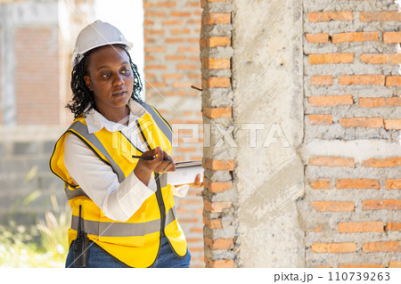 Engineer women black african professional worker working inspection quality check of construction site house building project. Engineer women black african professional worker working inspection quality check of construction site house building project. 110739263