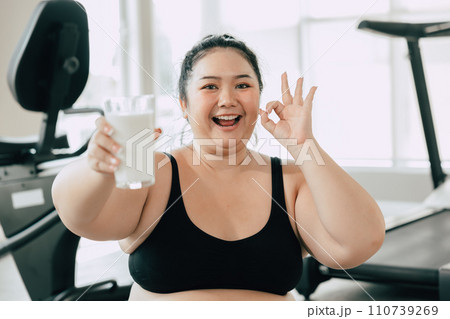 sport healthy fat women happy smiling enjoy drink milk and diet exercise activity in fitness sport club 110739269