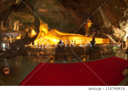 The golden reclining Buddha image is 14 meters long with perfect beauty at Wat Tham Suwan Khuha or Golden cave. This is a popular place for both Thai and foreign tourists. The golden reclining Buddha image is 14 meters long with perfect beauty at Wat Tham Suwan Khuha or Golden cave. This is a popular place for both Thai and foreign tourists. 110740618