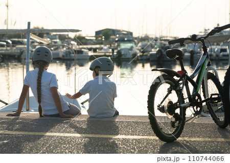 brother and sister ride bicycles on a sunny day brother and sister ride bicycles on a sunny day 110744066