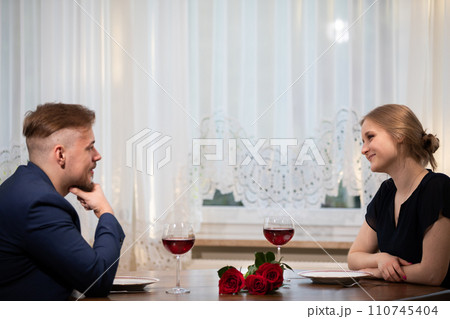 Boy and girl on an elegant date at home. Boy and girl on an elegant date at home. 110745404
