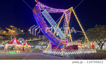 illuminated pirate ship swing boat ride in the amusement recreation park, Christmas market 110749822
