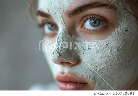 a woman with a facial mask on her face a woman with a facial mask on her face 110750991