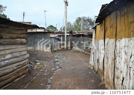 Dirty streets with leaning houses in Kenyan Kibera slum in Nairobi Dirty streets with leaning houses in Kenyan Kibera slum in Nairobi 110751477
