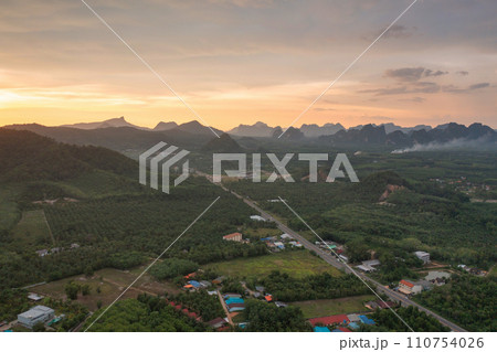 Aerial top view of Samet Nangshe, Phang Nga with city town, lush green trees from above in tropical forest in national park in summer season. Natural landscape. Pattern texture background. Aerial top view of Samet Nangshe, Phang Nga with city town, lush green trees from above in tropical forest in national park in summer season. Natural landscape. Pattern texture background. 110754026