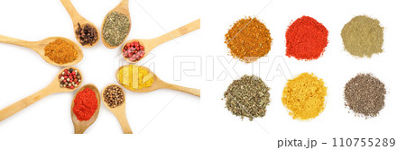 mix of spices on w isolated on wooden spoon a white background. Top view. Flat lay. Set or collection 110755289