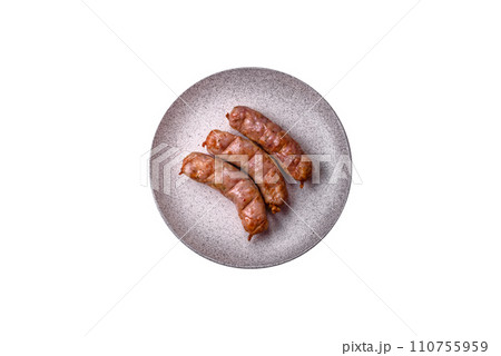 Delicious juicy grilled chicken or pork sausages with salt, spices and herbs 110755959