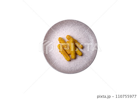 Delicious crispy cheese sticks with mozzarella, salt and spices, breaded and fried in oil 110755977