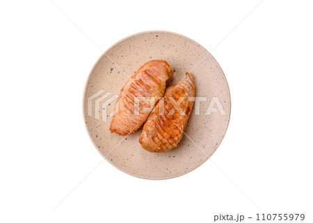 Delicious fresh grilled chicken fillet with spices and herbs on a dark concrete background 110755979