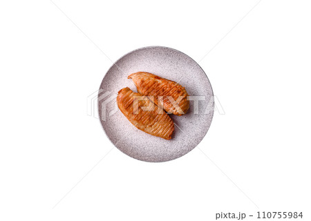 Delicious fresh grilled chicken fillet with spices and herbs on a dark concrete background 110755984