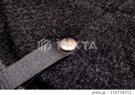 Button and strap on black knitted clothes 110756551