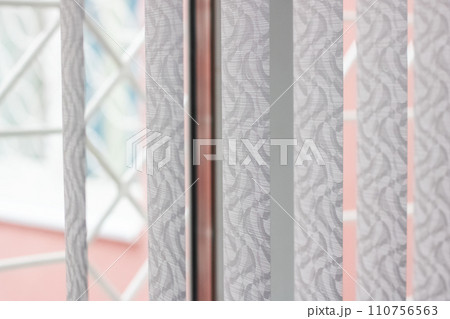 Vertical white blinds on a window closeup Vertical white blinds on a window closeup 110756563