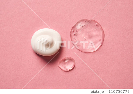 Gel, serum and a cream on a pink background. 110756775