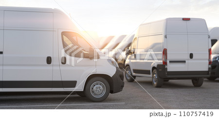 Express delivery, shipping service concept. Delivery vans in a row in the rays of sunset or dawn. 110757419