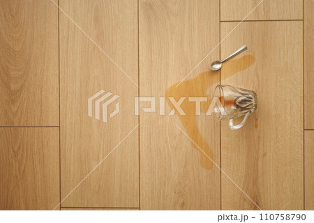 cup of coffee spilled on wooden floor cup of coffee spilled on wooden floor 110758790