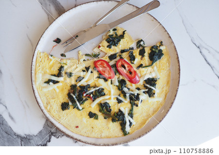 eating herb Egg Omelette on table eating herb Egg Omelette on table 110758886