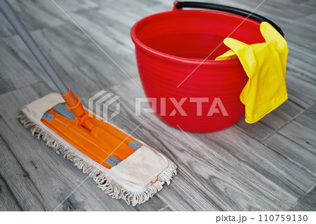 Mop, bucket of water, rubber gloves close-up. The concept of keeping your home clean and healthy. Mop, bucket of water, rubber gloves close-up. The concept of keeping your home clean and healthy. 110759130