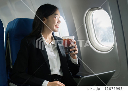 Beautiful Asian businesswoman working with laptop in aeroplane. working, travel, business concept Beautiful Asian businesswoman working with laptop in aeroplane. working, travel, business concept 110759924