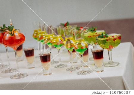 Welcome drink with cocktail glasses and drinks at an event. Alcoholic beverages at a wedding 110760387