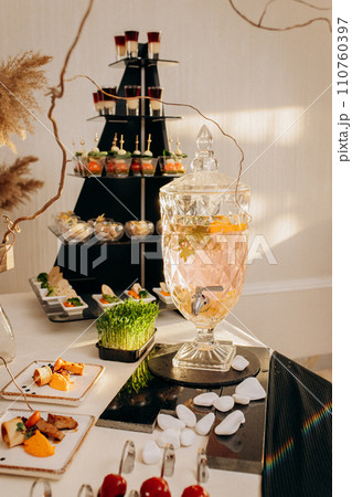 Assortment of delicious snacks on the open buffet festive table in restaurant. Catering plate 110760397