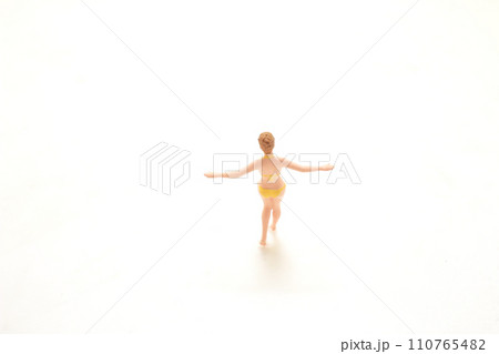 a Minimalist toy figure with outstretched arms on white background a Minimalist toy figure with outstretched arms on white background 110765482