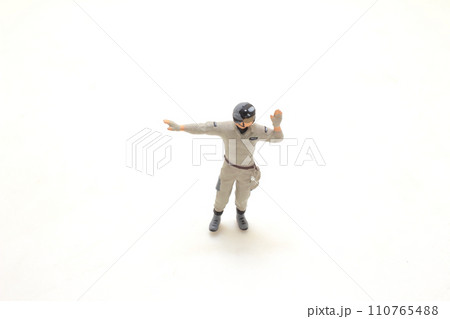 a Small figurine of a worker with raised fist on white background a Small figurine of a worker with raised fist on white background 110765488