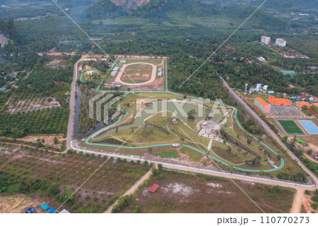 Aerial top view of garden park with lake or river in travel and environment concept. Nature landscape background in Thailand. Aerial top view of garden park with lake or river in travel and environment concept. Nature landscape background in Thailand. 110770273