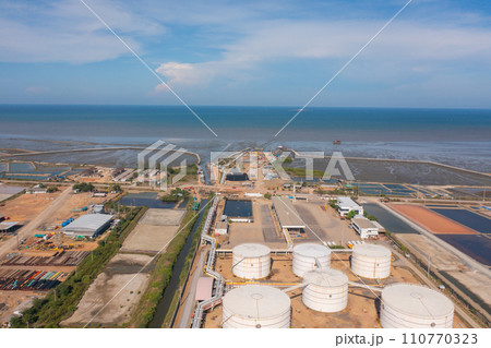 Aerial view of petrochemical oil refinery and sea in industrial engineering concept in Bangna district, Bangkok City, Thailand. Oil and gas tanks pipelines in industry. Modern metal factory. 110770323