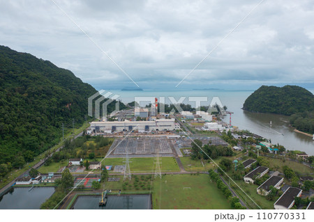Aerial view of electricity generating, voltage poles with sea b. Power lines on utility tower and cable wires in energy electric technology, and industry. Generator pylon. Transmission and substation. Aerial view of electricity generating, voltage poles with sea b. Power lines on utility tower and cable wires in energy electric technology, and industry. Generator pylon. Transmission and substation. 110770331