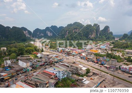 Aerial top view of Samet Nangshe, Phang Nga with city town, lush green trees from above in tropical forest in national park in summer season. Natural landscape. Pattern texture background. Aerial top view of Samet Nangshe, Phang Nga with city town, lush green trees from above in tropical forest in national park in summer season. Natural landscape. Pattern texture background. 110770350