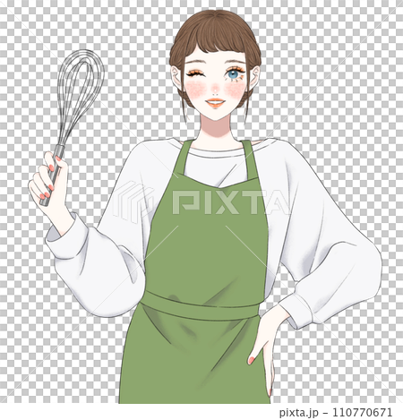 A woman in an apron holding a whisk 110770671