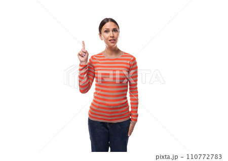 young caucasian woman with black hair dressed in a striped orange sweater draws attention young caucasian woman with black hair dressed in a striped orange sweater draws attention 110772783