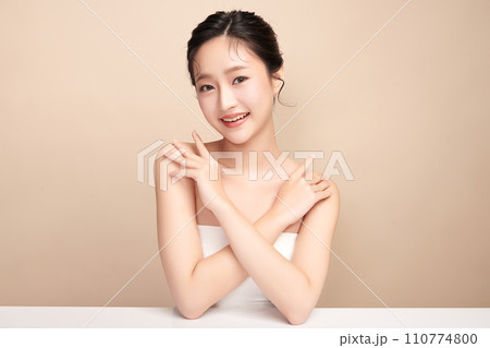 Beautiful young asian woman with clean fresh skin on beige background, Face care, Facial treatment, Cosmetology, beauty and spa, Asian women portrait. 110774800