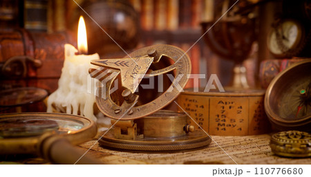 Vintage style travel and adventure. Vintage old compass and other vintage items on the table. 110776680