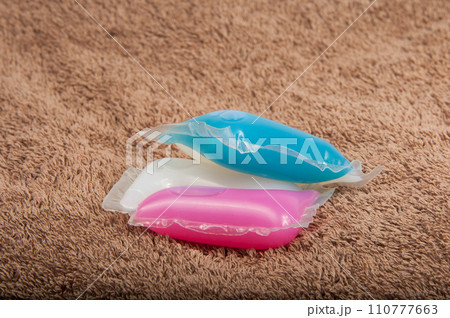 Washing color gel capsule on the brown cloth texture 110777663