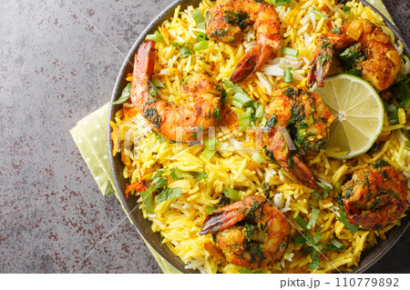 Persian Shrimp Rice Meygoo Polo with herbs and lime closeup on the plate. Horizontal top view 110779892