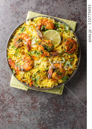 Meygoo Polo pilaf Rice with herbs and prawns closeup on the plate. Vertical top view Meygoo Polo pilaf Rice with herbs and prawns closeup on the plate. Vertical top view 110779893